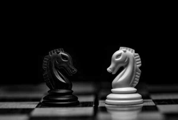 Chess pieces on a dark board, representing the difference between fixed automation rules and AI agents making bounded decisions
