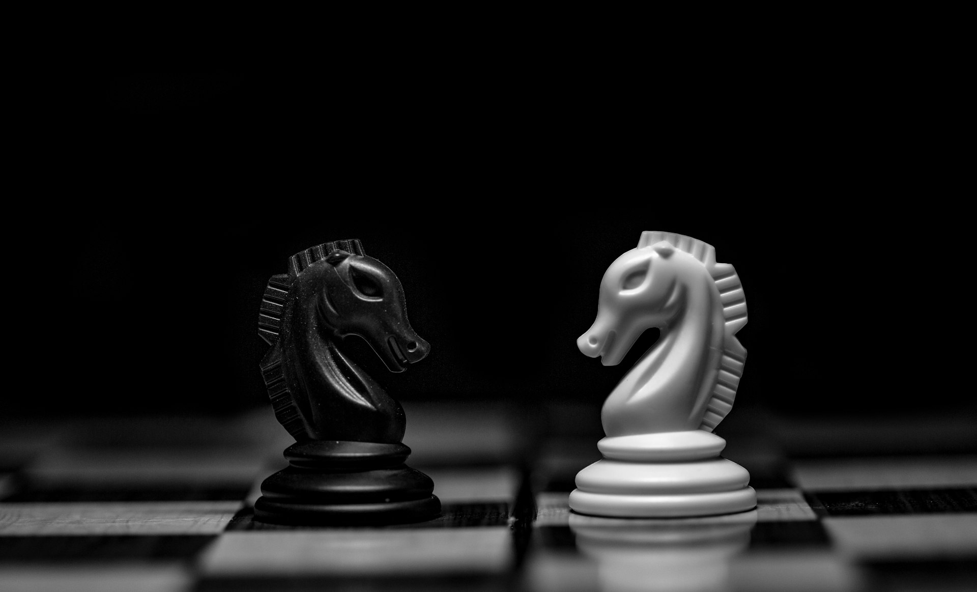 Chess pieces on a dark board, representing the difference between fixed automation rules and AI agents making bounded decisions