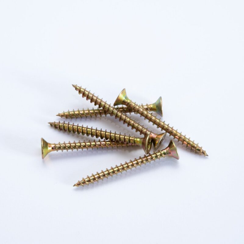 Rows of brass screws laid precisely on stone, representing twenty five small, repeatable AI automations for Alberta businesses
