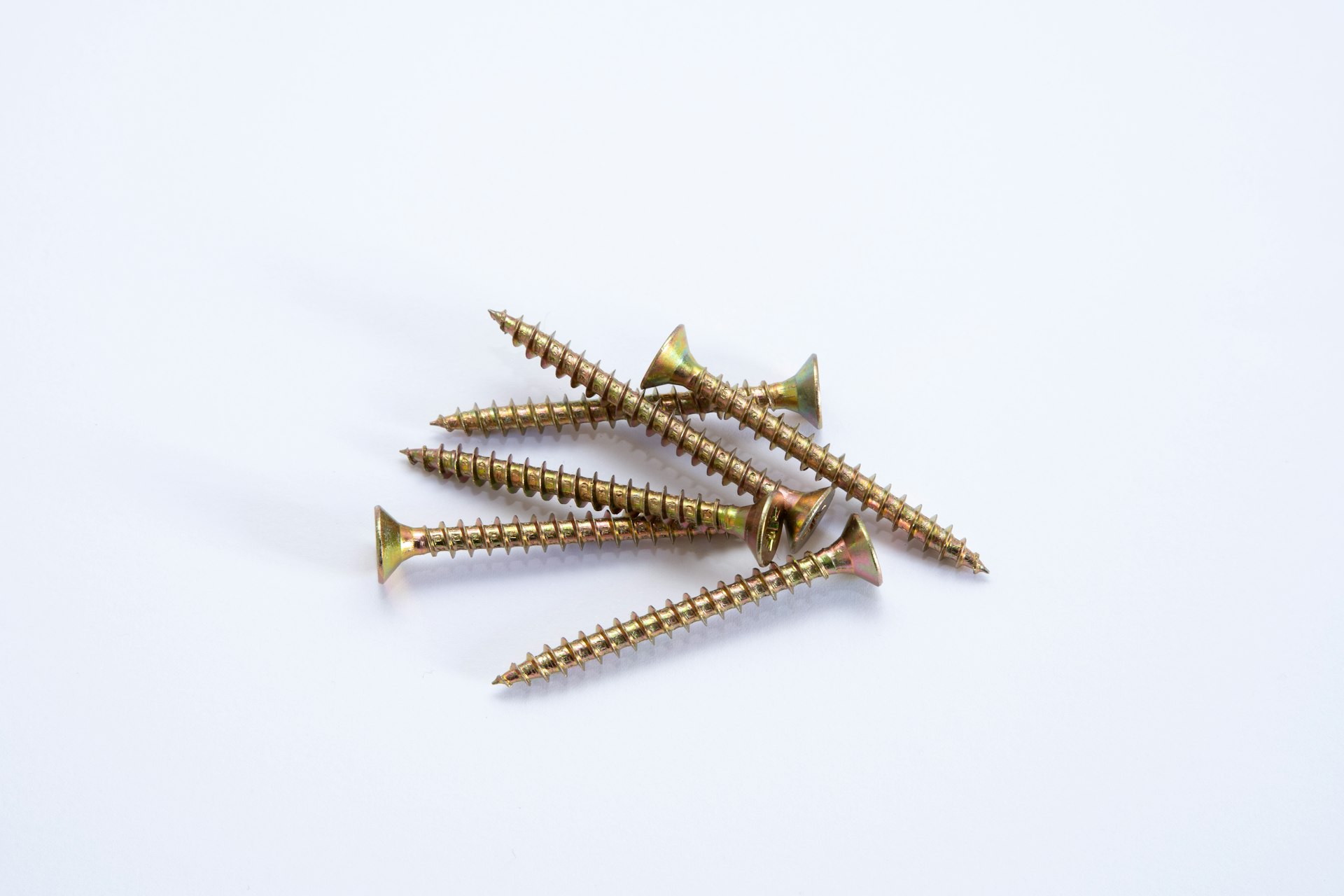 Rows of brass screws laid precisely on stone, representing twenty five small, repeatable AI automations for Alberta businesses