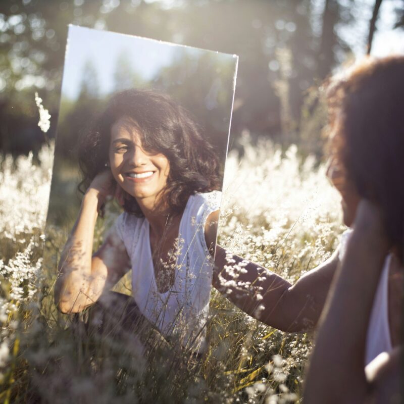 A person reflected in a mirror, representing the question of when an AI avatar clone protects trust and when it puts trust at risk