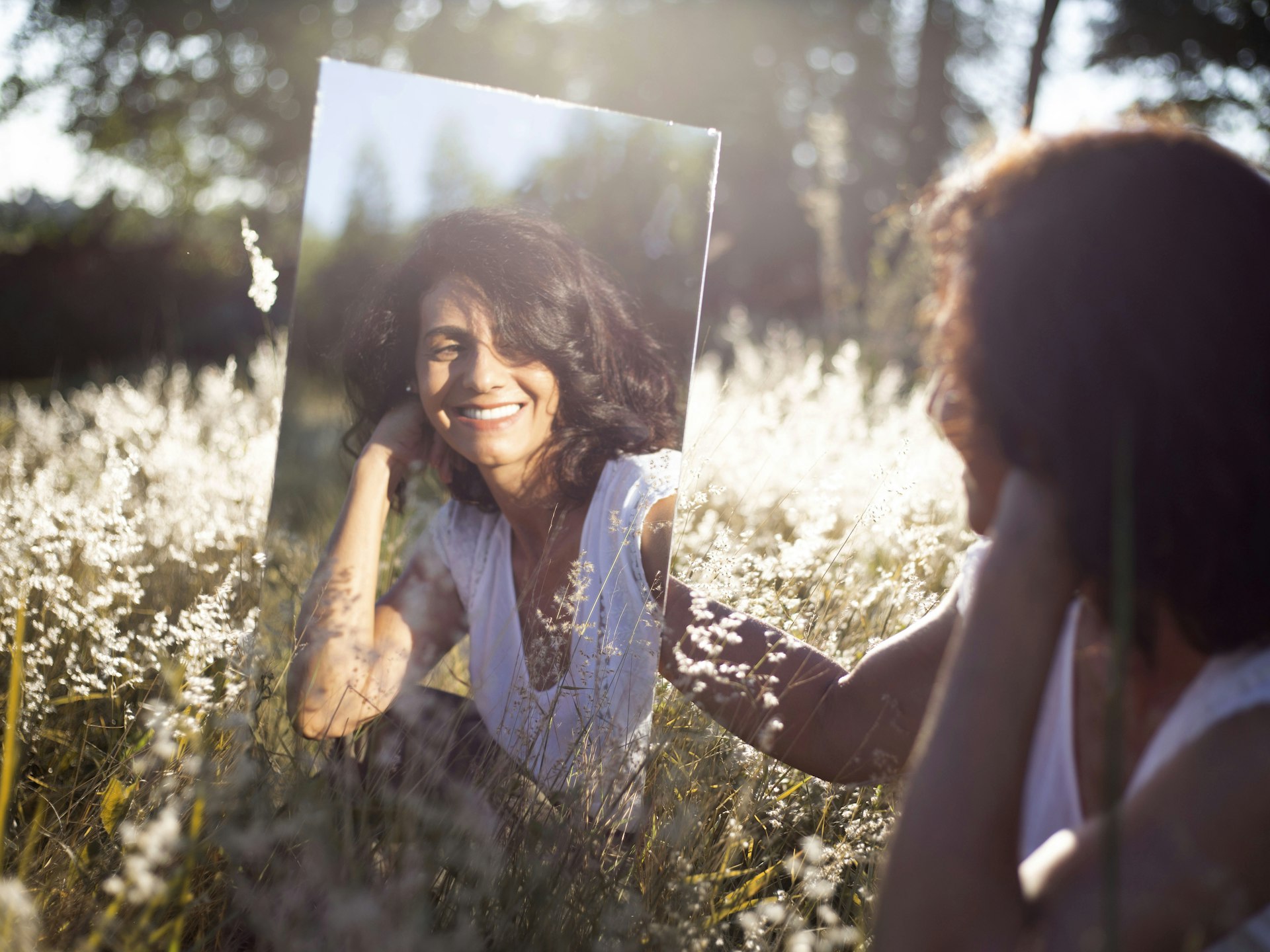 A person reflected in a mirror, representing the question of when an AI avatar clone protects trust and when it puts trust at risk