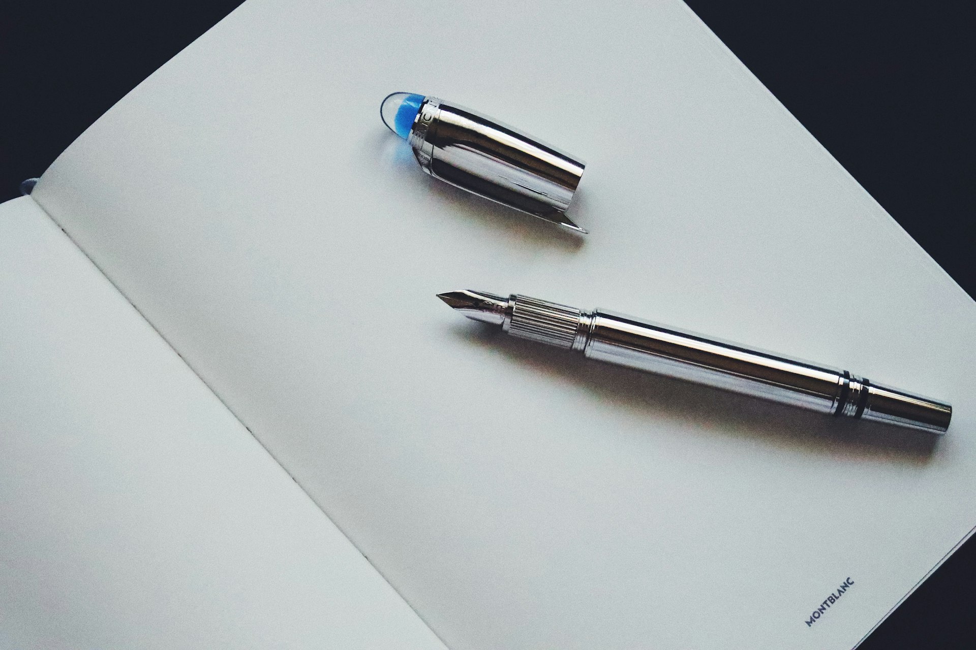 A fountain pen resting on an open ledger page, representing the decisions that should be made before signing off an AI budget line