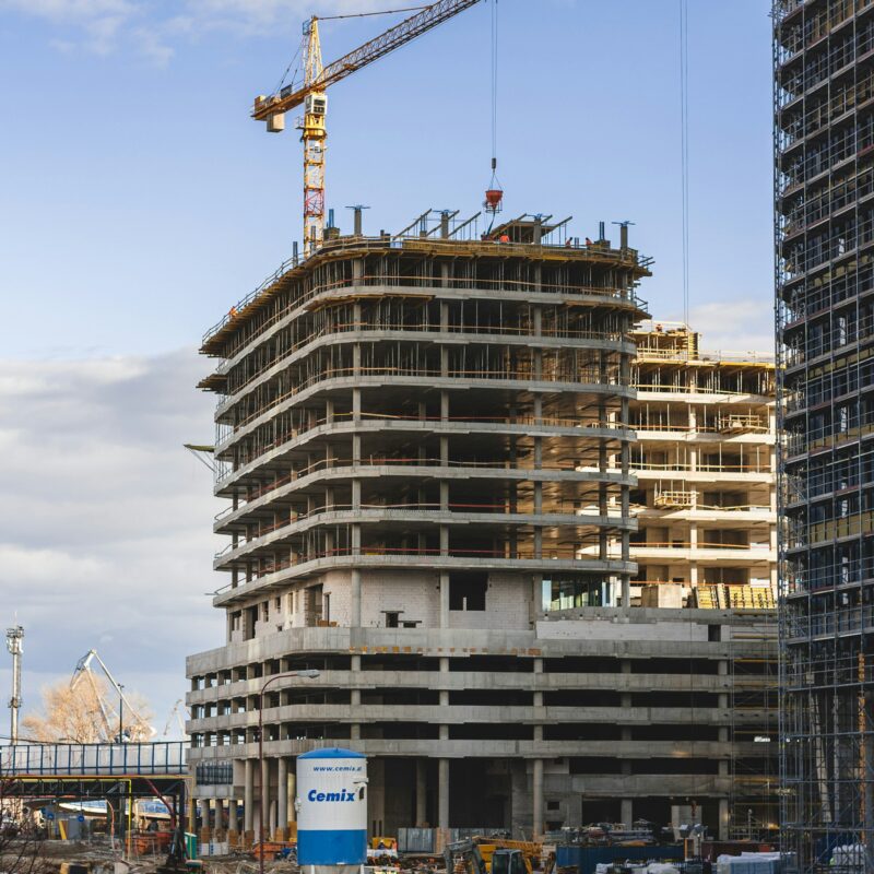 A raw concrete slab on an active construction site, representing the paperwork and documentation surrounding Alberta construction work