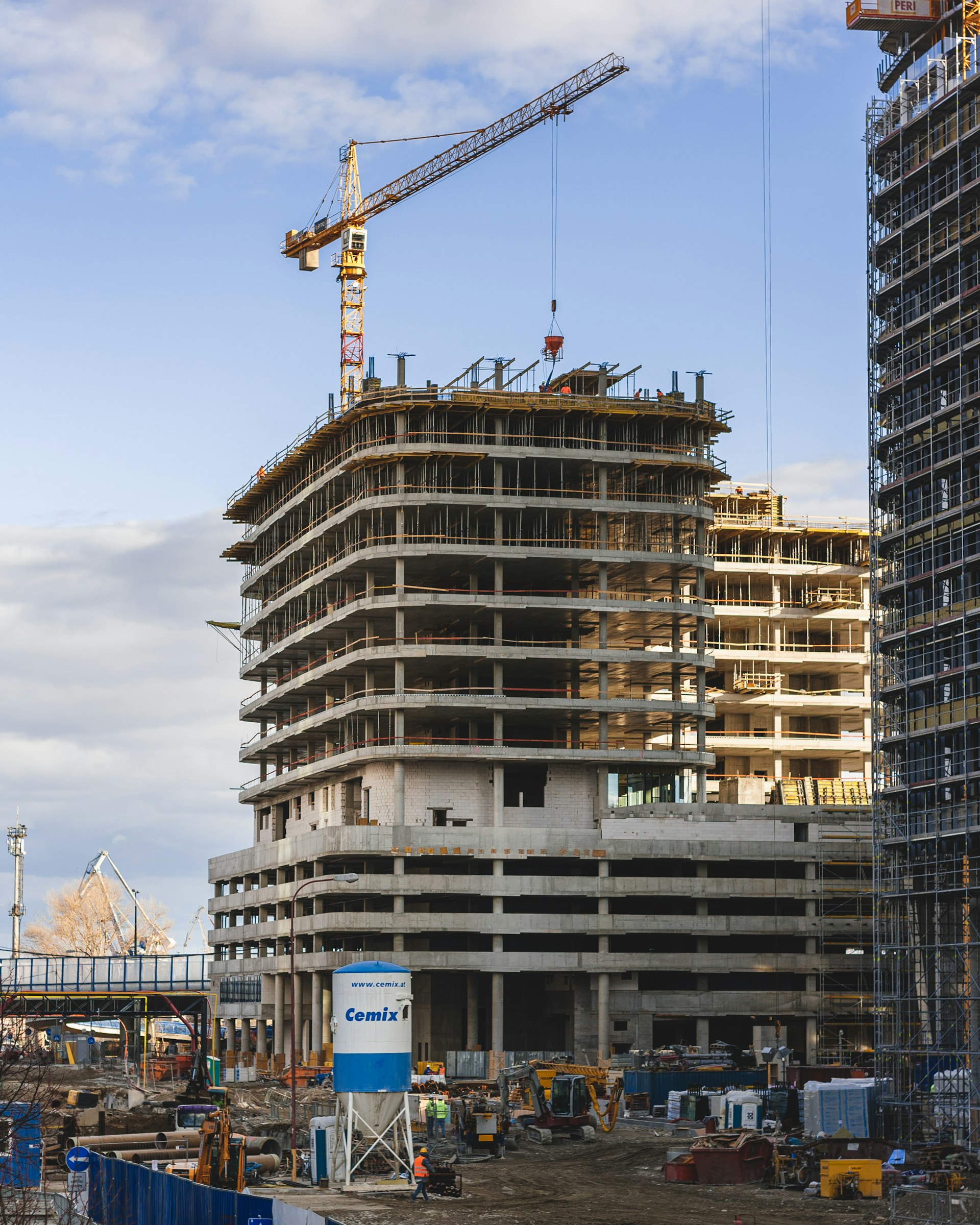 A raw concrete slab on an active construction site, representing the paperwork and documentation surrounding Alberta construction work