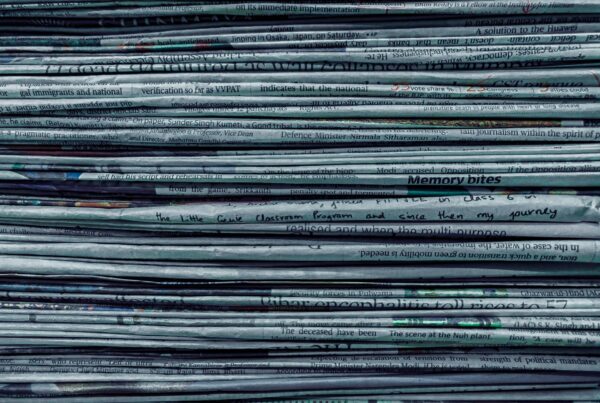 The compressed edge of a stacked set of paper on a desk, representing billable time and document work in Calgary professional services firms