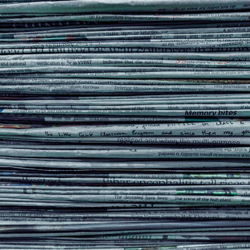 The compressed edge of a stacked set of paper on a desk, representing billable time and document work in Calgary professional services firms
