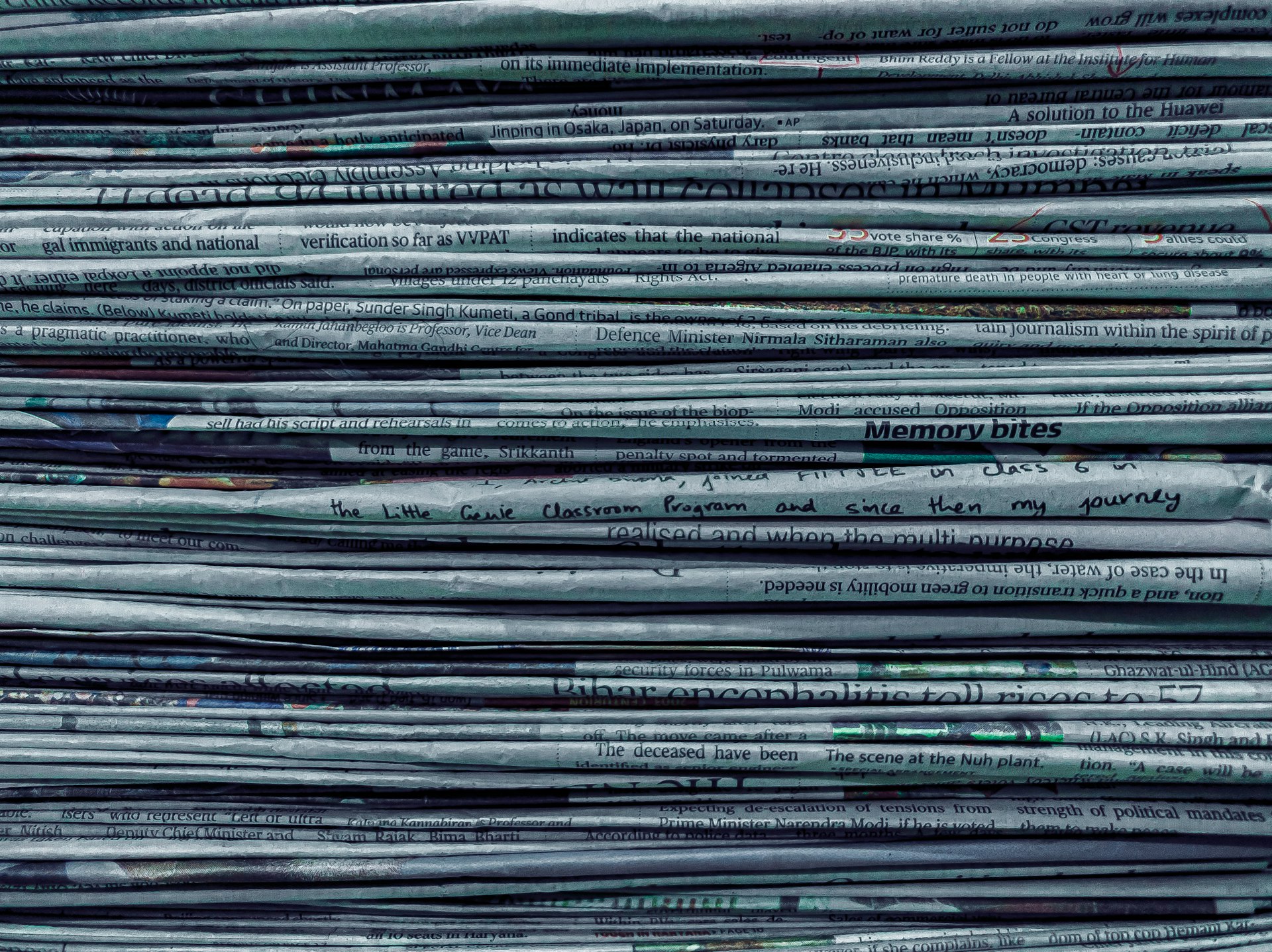 The compressed edge of a stacked set of paper on a desk, representing billable time and document work in Calgary professional services firms