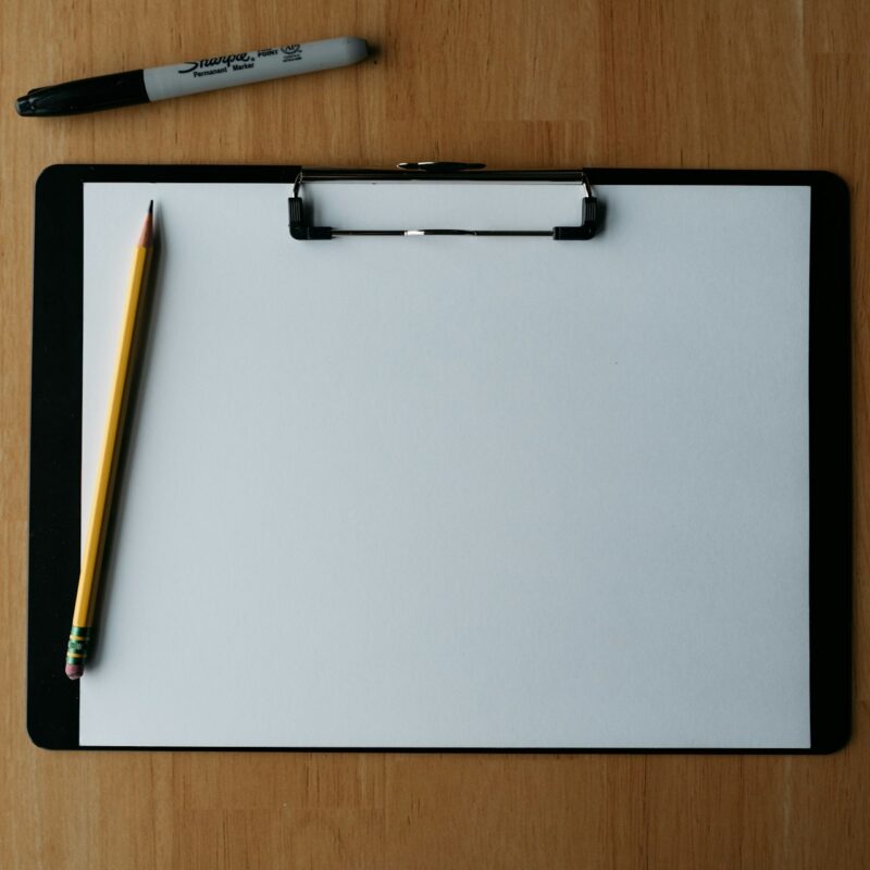 A clipboard with a checklist on a desk, representing a practical AI governance checklist for growing companies