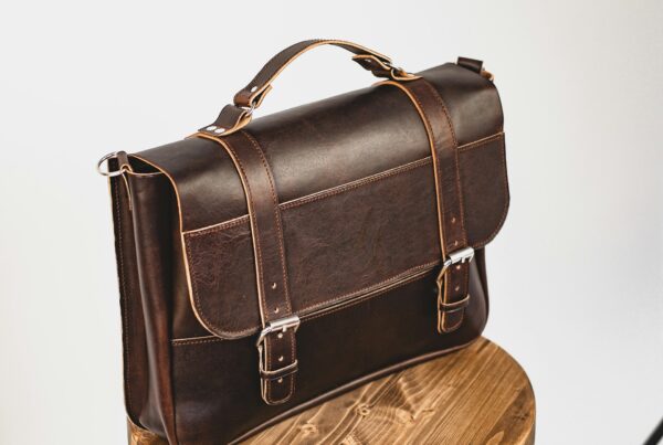 A leather briefcase on a desk, representing where accounting, legal, and consulting firms see the earliest return from AI
