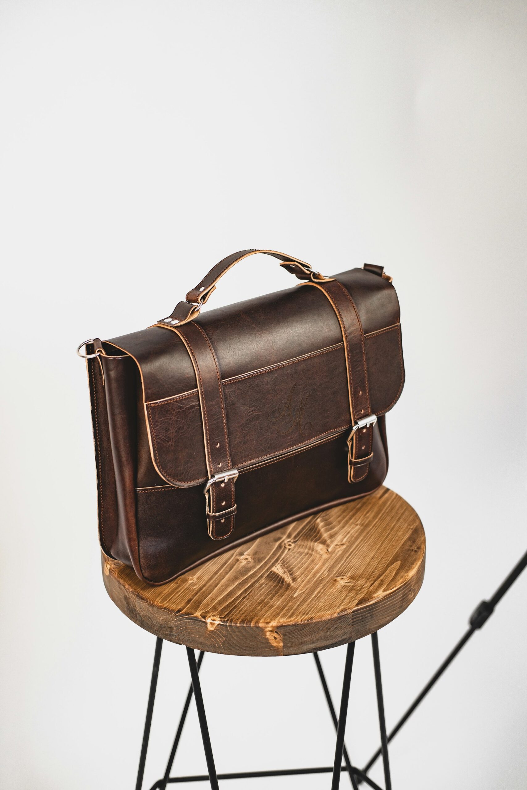 A leather briefcase on a desk, representing where accounting, legal, and consulting firms see the earliest return from AI
