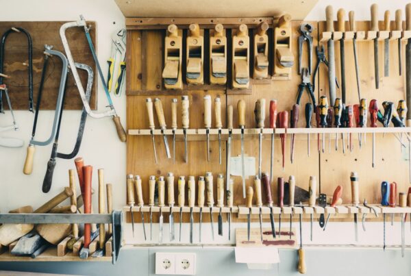 A quiet workshop with tools laid out on a bench, representing the slower season used to map and build business systems