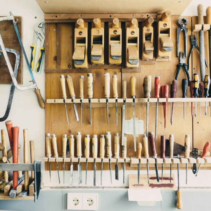 A quiet workshop with tools laid out on a bench, representing the slower season used to map and build business systems