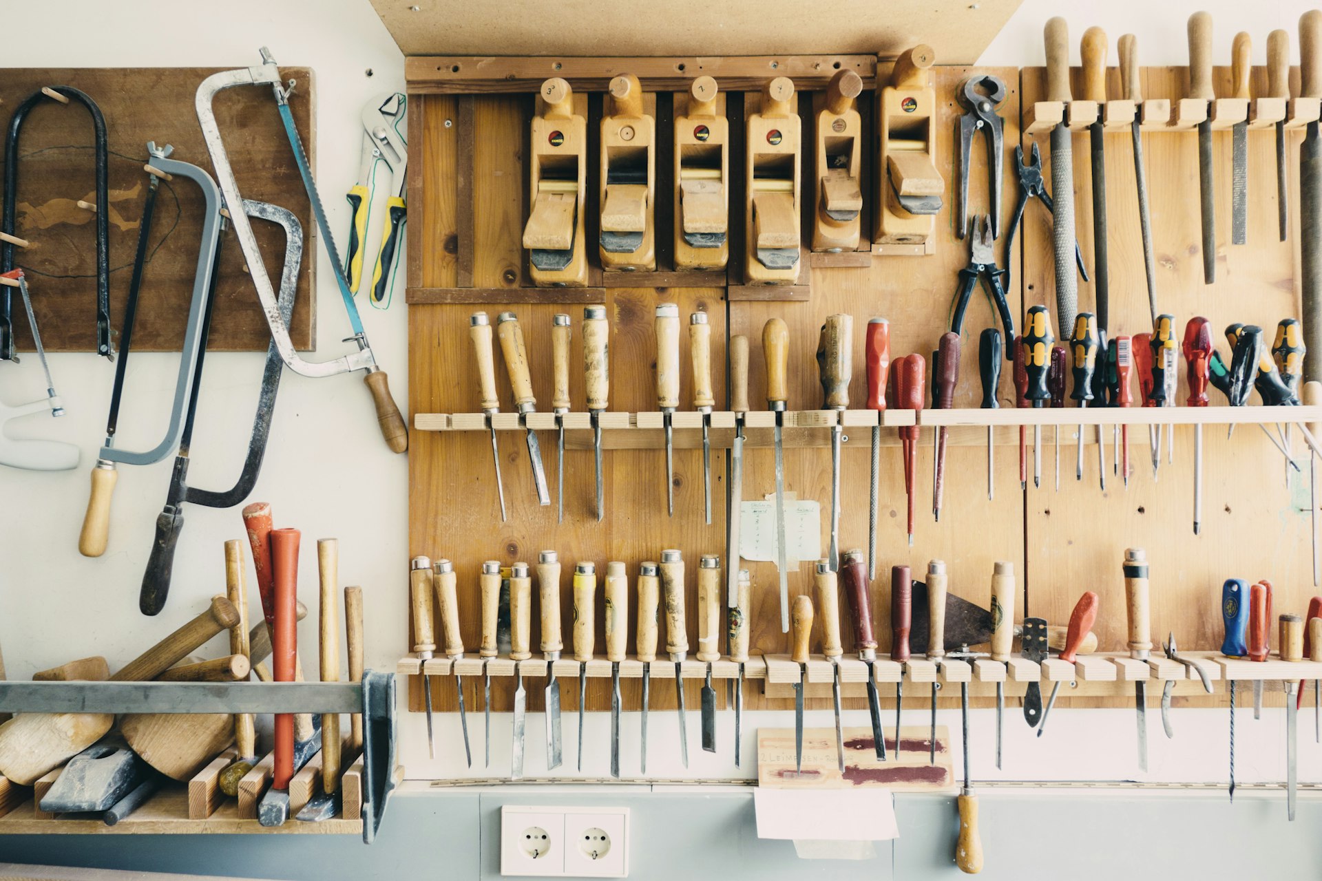 A quiet workshop with tools laid out on a bench, representing the slower season used to map and build business systems