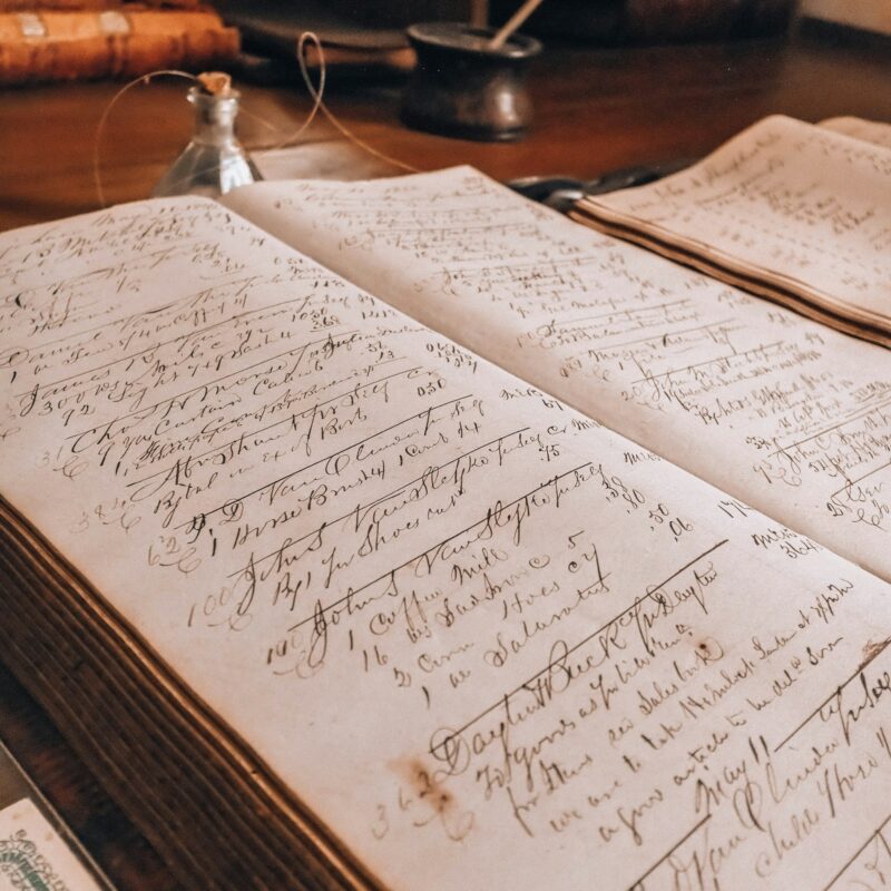 A vintage ledger book open on a desk, representing the financial scrutiny a CFO applies to an AI spending proposal