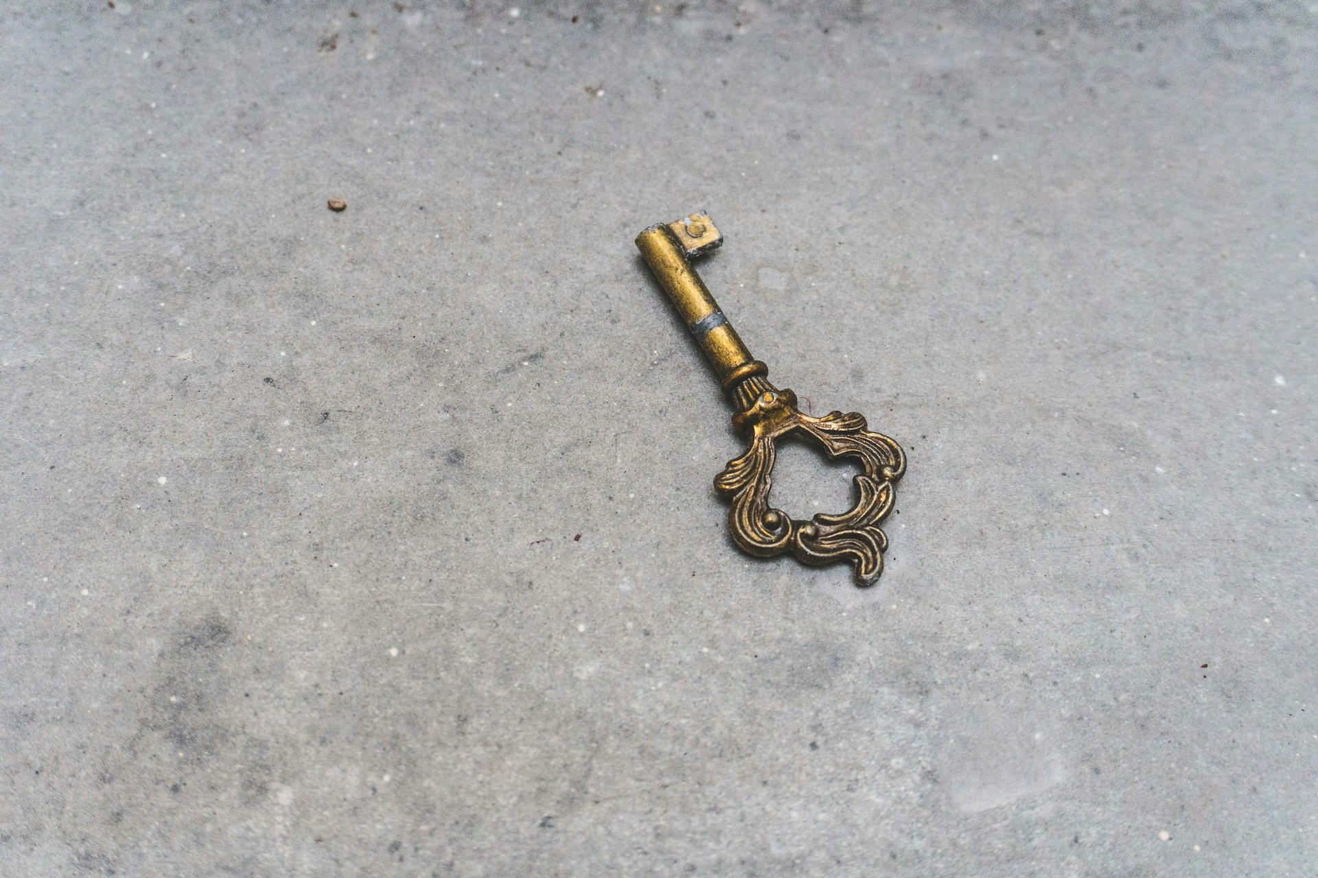 Two brass keys of different complexity resting on marble, representing the choice between a simple chatbot and a more capable AI agent