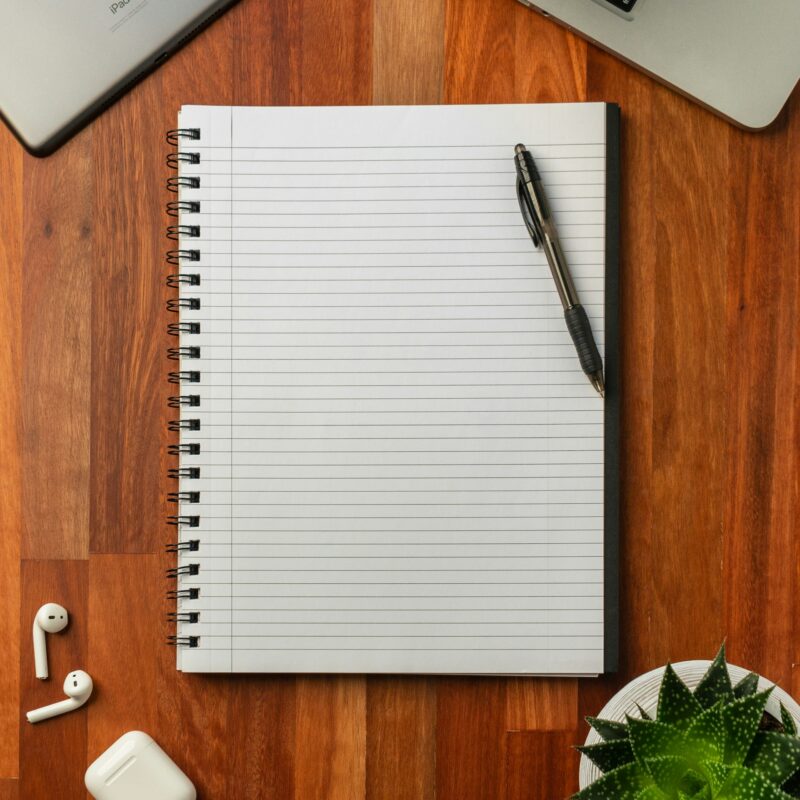 An open notebook and pen on a desk, representing fifteen ChatGPT workflows worth turning into shared company templates