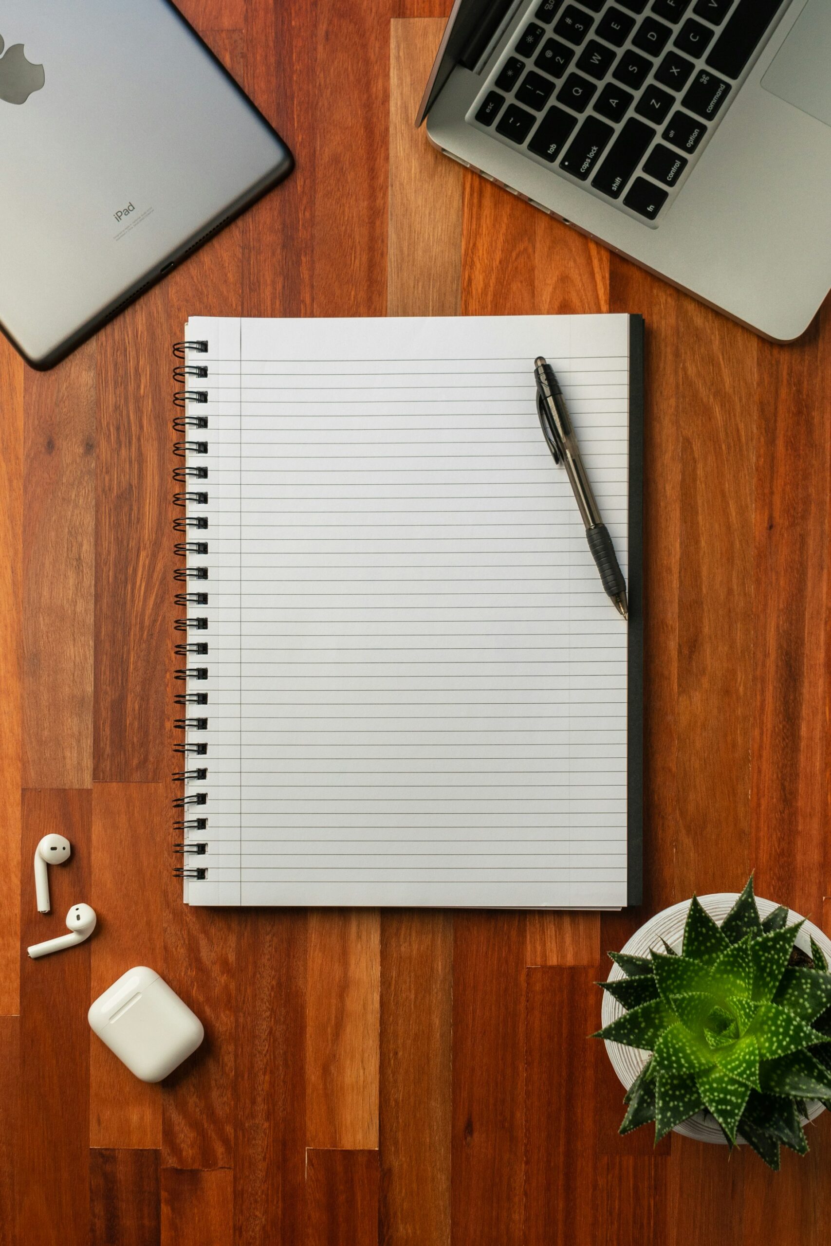 An open notebook and pen on a desk, representing fifteen ChatGPT workflows worth turning into shared company templates