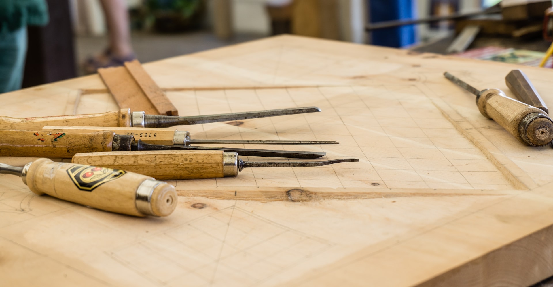 Two pieces of pale oak joined by a hand-cut lap joint, representing bringing a team into an AI change instead of imposing it on them