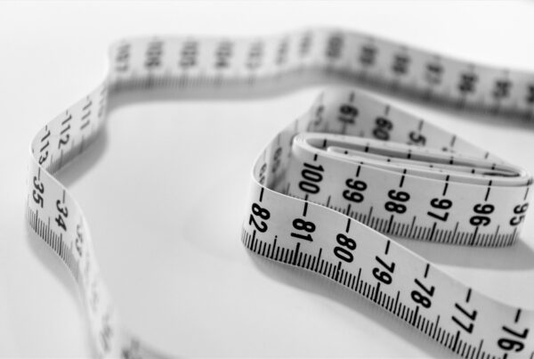 A macro shot of a measuring tape, representing the discipline of measuring AI return with a real baseline