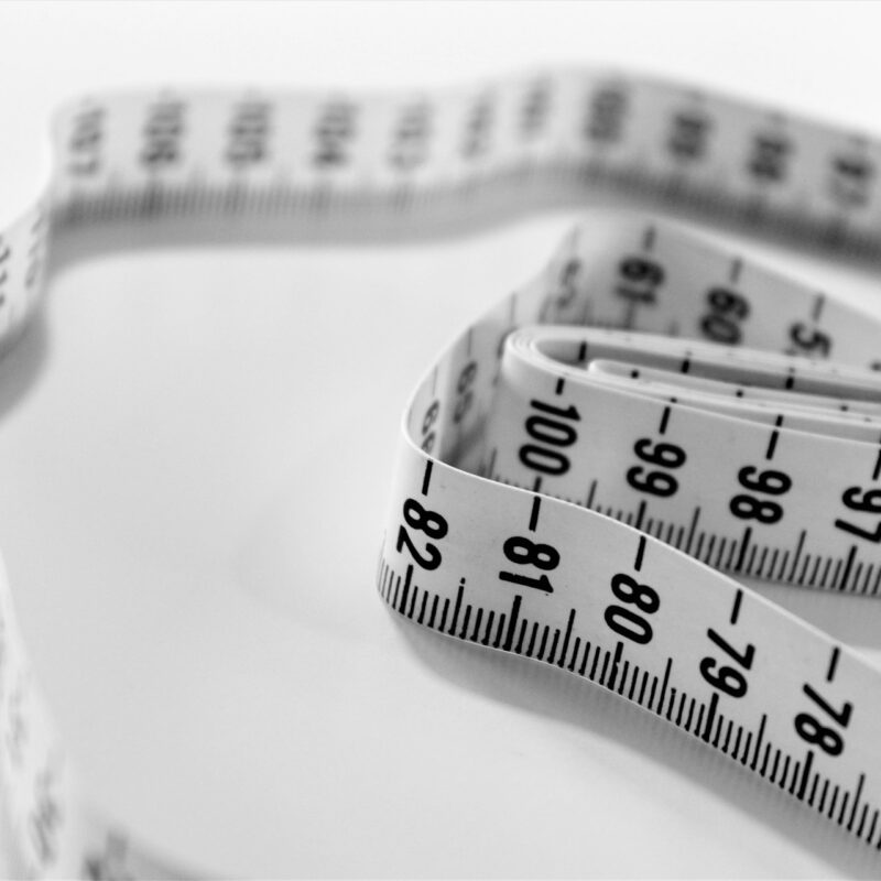 A macro shot of a measuring tape, representing the discipline of measuring AI return with a real baseline
