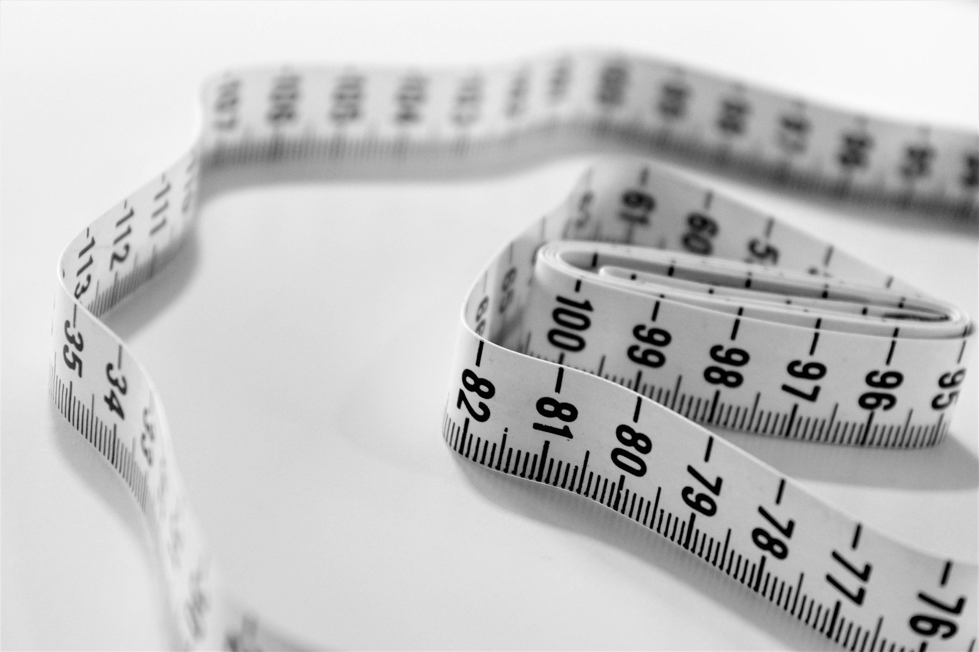 A macro shot of a measuring tape, representing the discipline of measuring AI return with a real baseline