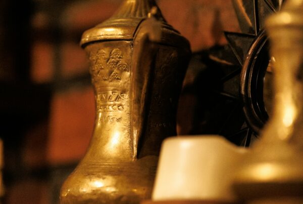 A set of graduated brass weights arranged in a row, representing scoring and ranking AI use cases by value and risk