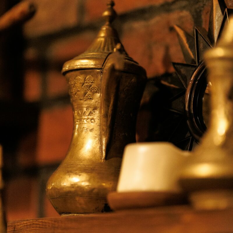 A set of graduated brass weights arranged in a row, representing scoring and ranking AI use cases by value and risk