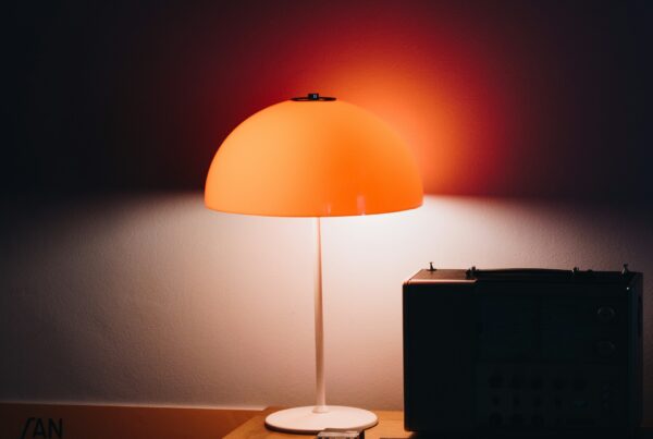 A flashlight beam cutting through a dark office, representing shadow AI use already happening inside a company