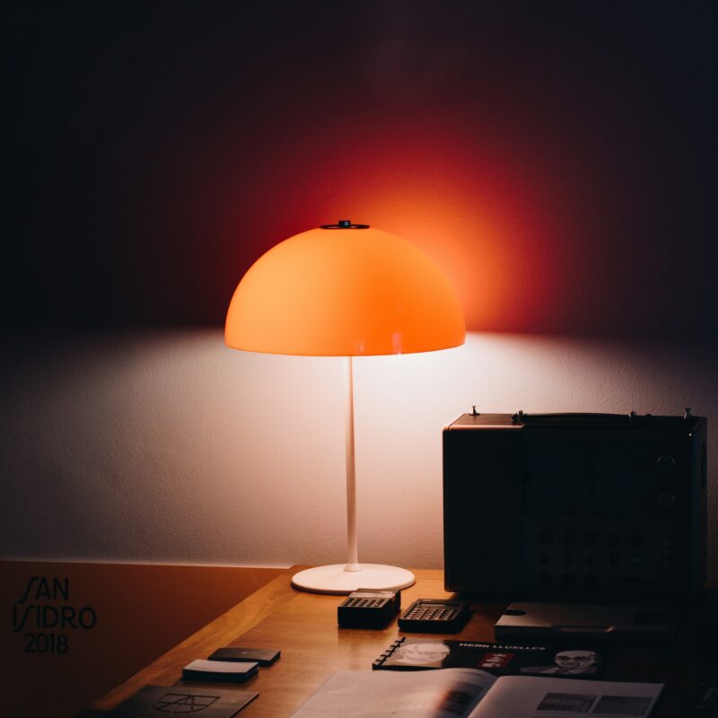 A flashlight beam cutting through a dark office, representing shadow AI use already happening inside a company