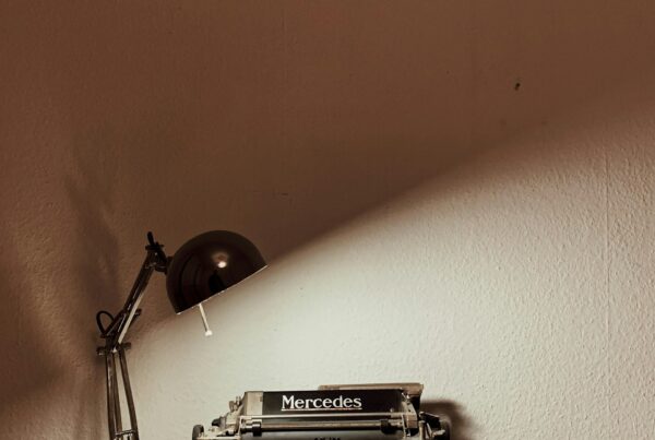 A vintage typewriter on a desk, representing the line between AI-assisted production work and human-led brand positioning in marketing