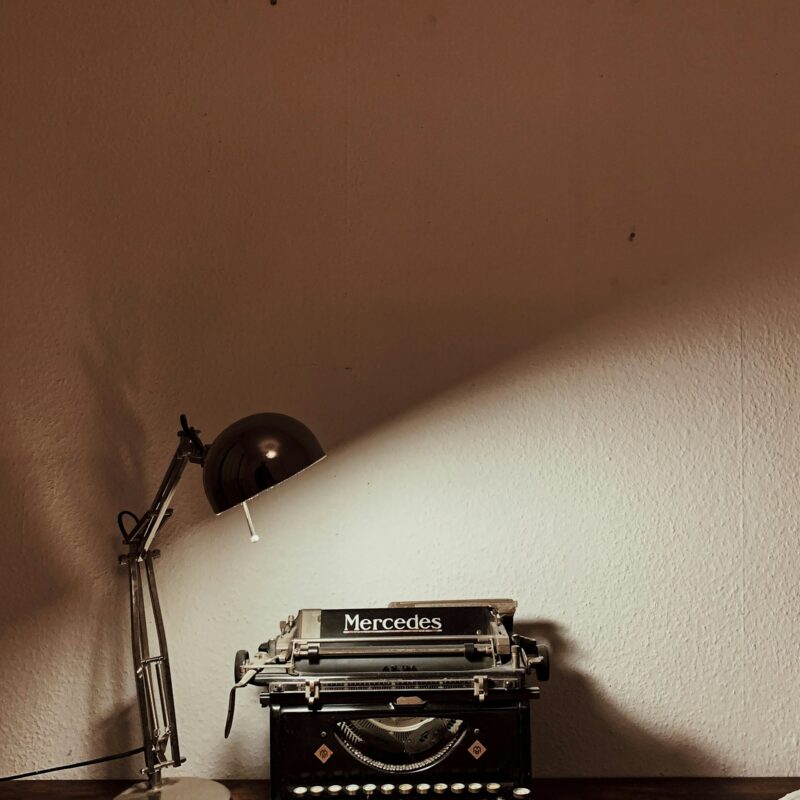 A vintage typewriter on a desk, representing the line between AI-assisted production work and human-led brand positioning in marketing