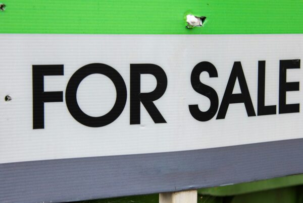 For sale sign in front of a home, illustrating AI for Alberta real estate