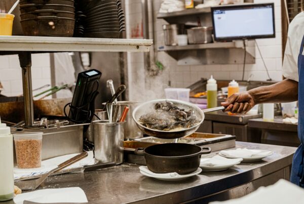 Cook preparing food in a restaurant kitchen, illustrating AI for restaurants