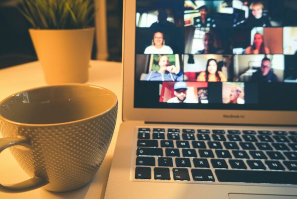 Laptop showing a video meeting beside a coffee mug, illustrating AI note taker privacy