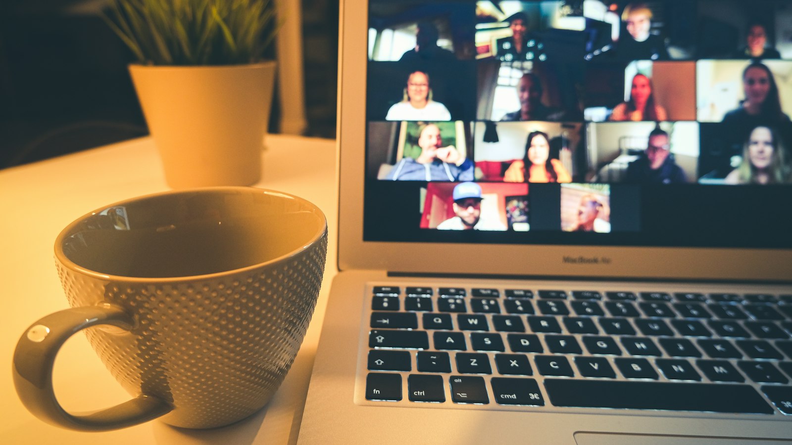 Laptop showing a video meeting beside a coffee mug, illustrating AI note taker privacy