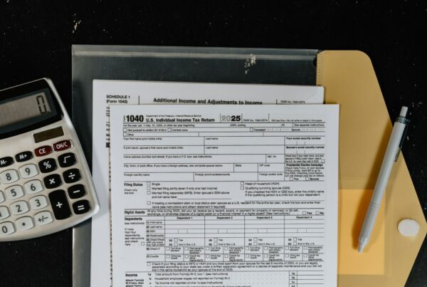 Printed financial statements beside a calculator