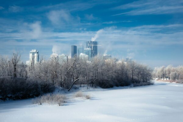 A frozen river and a city skyline in winter