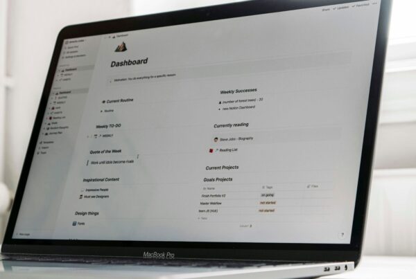 A laptop showing a spreadsheet on a desk