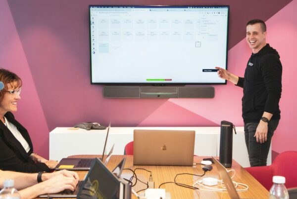 A facilitator presenting to a small group in a workshop room