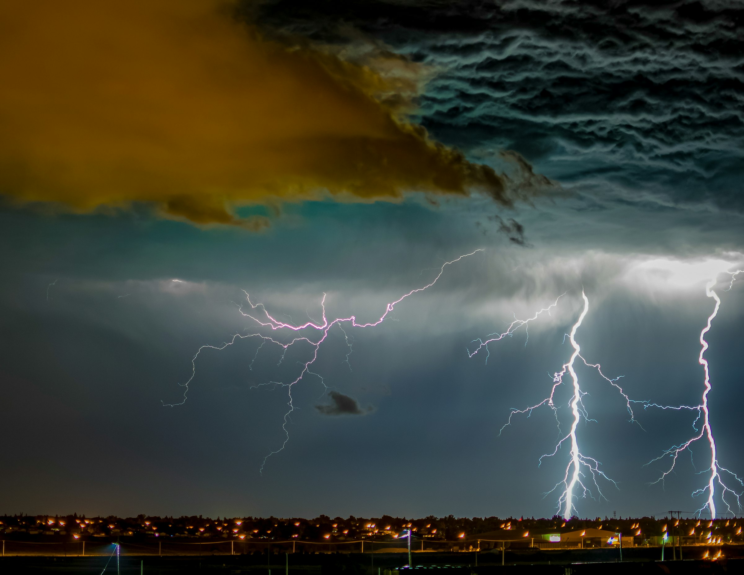 Lightning over the lights of Moose Jaw at night, Saskatchewan