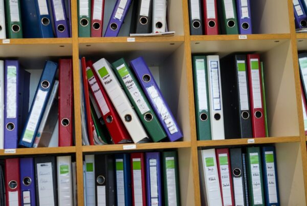 Rows of labelled binders on office shelves