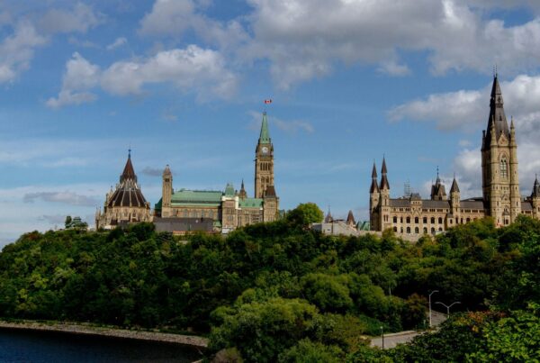 Parliament Hill in Ottawa seen across the Ottawa River under a partly cloudy sky