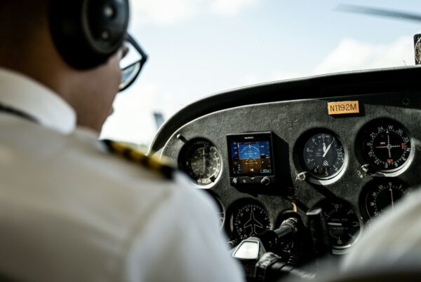 Two pilots running checks in an aircraft cockpit