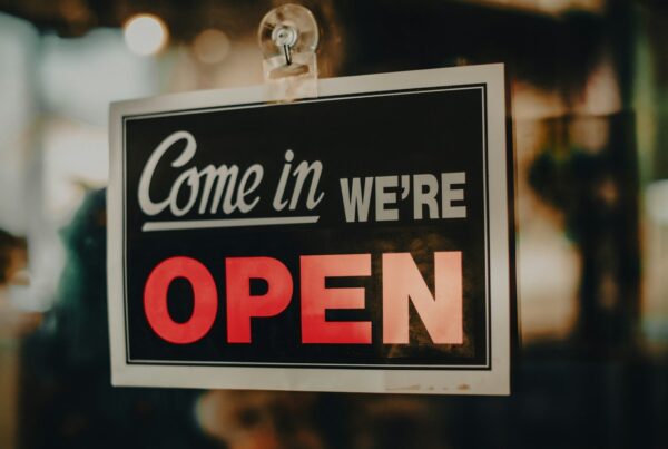 Come in, we're open sign in a shop window, illustrating how a business can show up in AI search