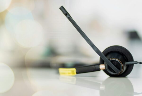A customer support headset resting on a desk