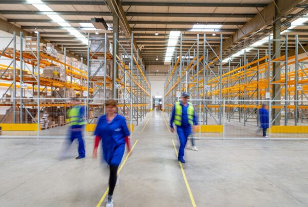 A team at work on the floor of a large warehouse
