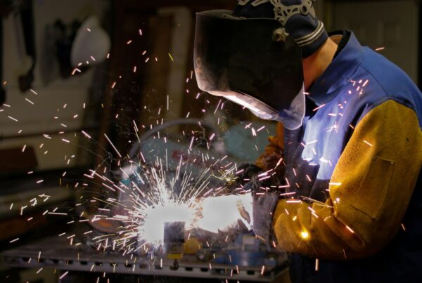 A welder at work with sparks flying