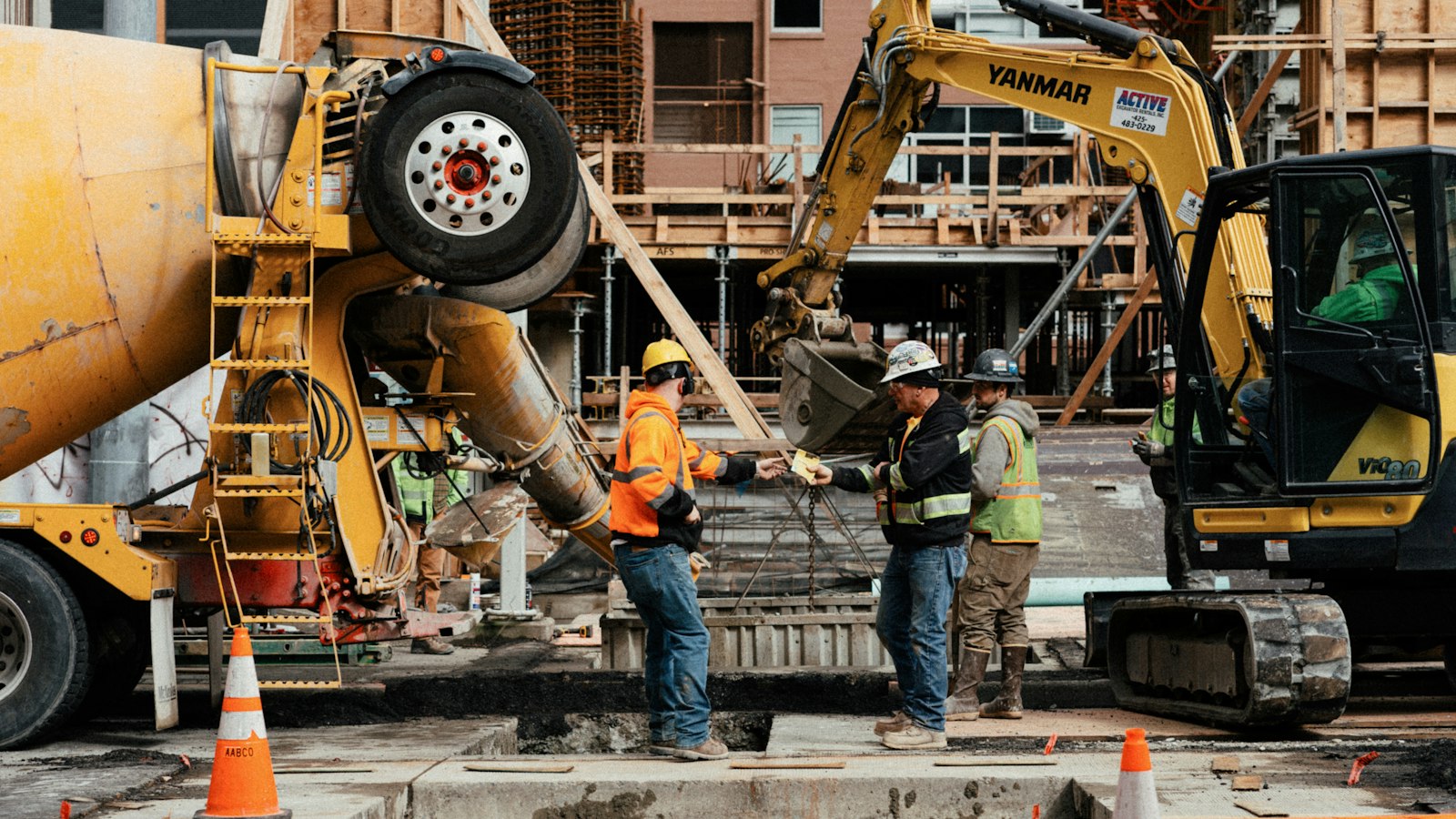 Construction workers on a building site, illustrating the question will AI replace jobs