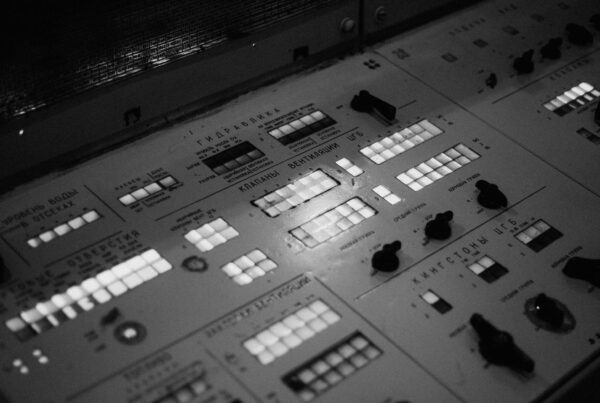 A control panel of switches and rows of indicator lights.